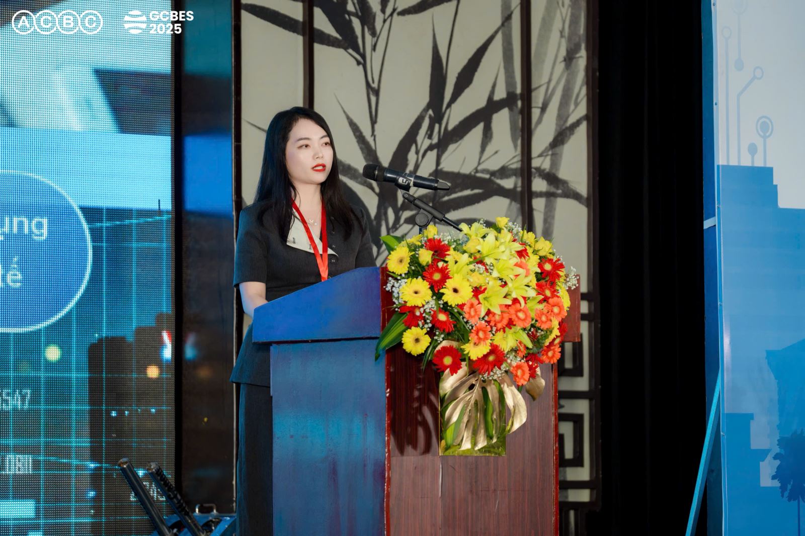 A person standing at a podium with a large bouquet of flowersAI-generated content may be incorrect.